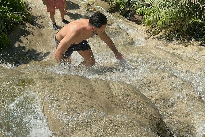 7 Hour Sticky Waterfall and Zipline Adventure - Climbing Bua Thong Falls up the waterfall on grippy limestone