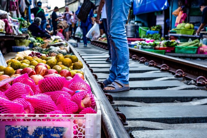 Amphawa Floating Market & Maeklong Railway Train Market Tour - Stop 2 at Wat Bang Kung: banyan roots, Buddha statues, and temple rules