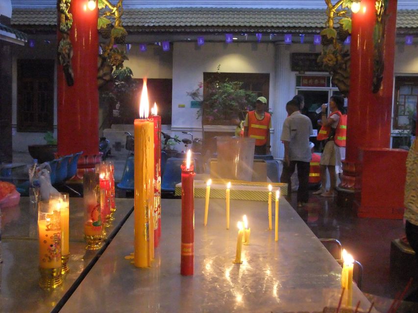 Bangkok by Night Cycling Tour with Street-food Meal - Chinatown after dark: lanterns, shop signs, and dinner crowds