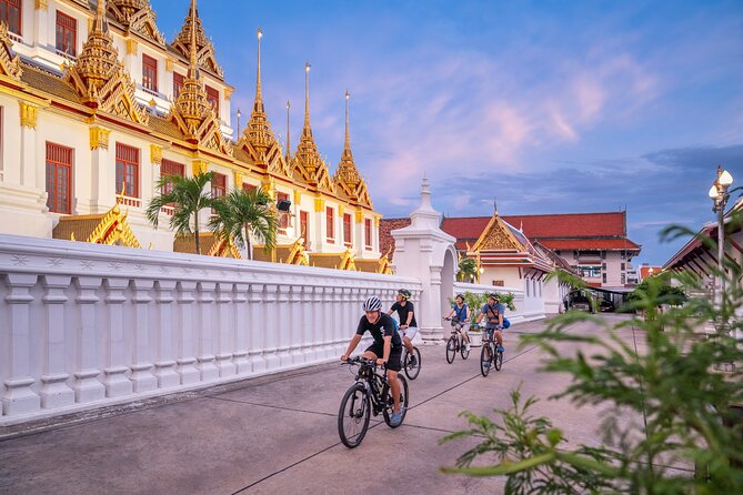 Bangkok: Night Bike Tour with Temples & Flower Market Visit - Loha Prasat and Rama VIII Bridge: iconic sights reached without walking your way there