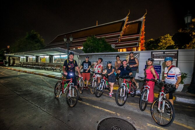 Bangkok: Night Bike Tour with Temples & Flower Market Visit - Wat Rakang Kositaram and Pak Khlong Flower Market at night